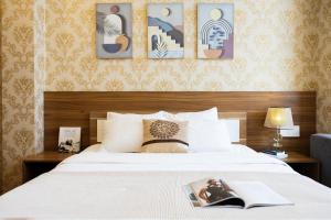 Postel nebo postele na pokoji v ubytování TTR Vincent Hotel