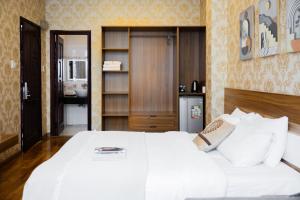 Postel nebo postele na pokoji v ubytování TTR Vincent Hotel