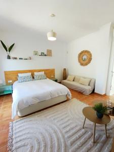 a bedroom with a large bed and a rug at B&B Villa Pinos Málaga in Alhaurín de la Torre +34 photos