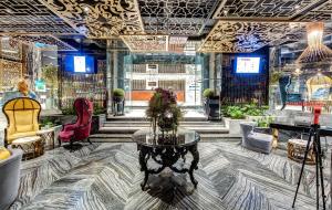 a lobby with a table and chairs in a room at The Elysium Taksim in Istanbul