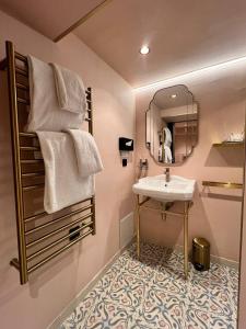 a bathroom with a sink and a mirror at Hotel Du Cadran in Paris +83 photos
