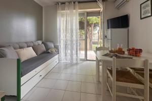 a small living room with a couch and a table at Residenza Pierre & Vacances Luni Mare in Luni +34 photos