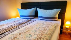 a bed with two pillows on top of it at Café am Hirschgrund in Kurort Rathen
