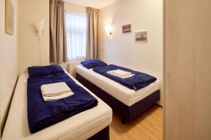 Postel nebo postele na pokoji v ubytování De Pelikaan Texel Appartementen