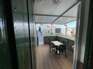 a patio with a table and chairs on a balcony at Casa rural VTAR con piscina in Rosal de la Frontera