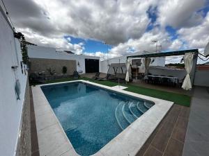 a swimming pool on the roof of a house at Casa rural VTAR con piscina in Rosal de la Frontera