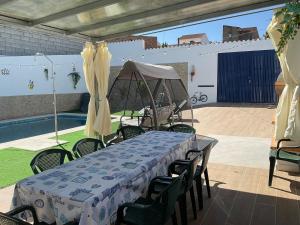 a table and chairs with a tent on a patio at Casa rural VTAR con piscina in Rosal de la Frontera