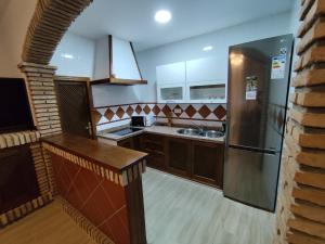 a kitchen with a stainless steel refrigerator and a sink at Casa Abuela Encarna in Hornachuelos