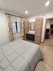 a bedroom with a large white bed in a room at Casa Abuela Encarna in Hornachuelos