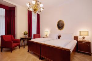 A bed or beds in a room at Graben Hotel