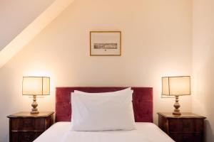 A bed or beds in a room at Graben Hotel