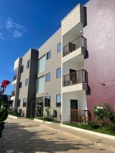 an apartment building with balconies on the side of it at First HR Hotel in Prampram
