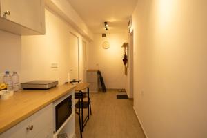a kitchen with a counter and a table in a room at Red Lake Apartman in Lacu Rosu +3 photos