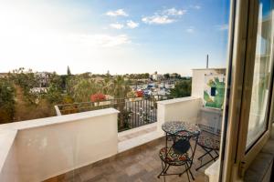 a balcony with two chairs and a view of a city at La Casetta sul Mare in Isola delle Femmine