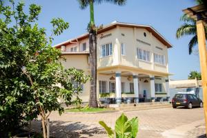 a building with a palm tree in front of it at YO ki GA li in Kigali