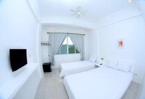 Postel nebo postele na pokoji v ubytování Coron Bluewave Hotel