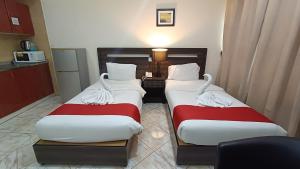 Postel nebo postele na pokoji v ubytování Ruwi Beach Hotel Apartments - MAHA HOSPITALITY GROUP
