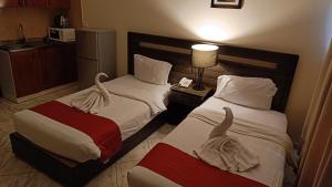 Postel nebo postele na pokoji v ubytování Ruwi Beach Hotel Apartments - MAHA HOSPITALITY GROUP