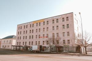a building with a truck parked in front of it at New hotel BEKARYS in Astana