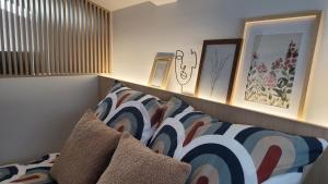 a bedroom with a bed and some pictures on the wall at Apartamenty Wyspa Jastarnia Morski in Jastarnia