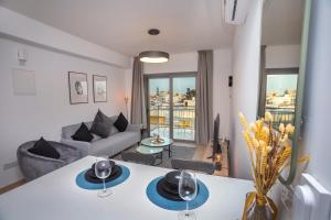 a living room with a couch and a table at Crown Hall Suites in Limassol