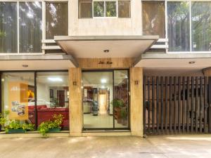 a store front with glass doors and windows at Capital O Hotel Suites Marne, Mexico City in Mexico City