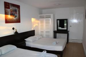 Postel nebo postele na pokoji v ubytování OYO Hotel Colibri