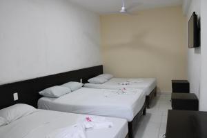 Postel nebo postele na pokoji v ubytování OYO Hotel Colibri