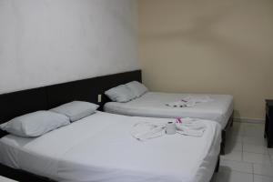 Postel nebo postele na pokoji v ubytování OYO Hotel Colibri