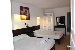 Postel nebo postele na pokoji v ubytování OYO Hotel Colibri