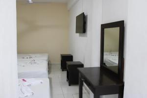 Postel nebo postele na pokoji v ubytování OYO Hotel Colibri