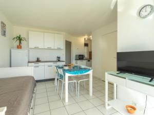 a living room with a table and a kitchen at Apartment Parc de Pontaillac-3 by Interhome in Pontaillac
