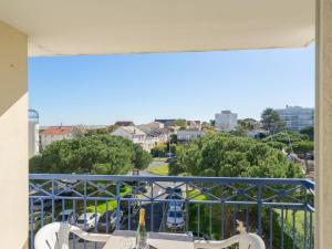 a balcony with a table and chairs and trees at Apartment Parc de Pontaillac-3 by Interhome in Pontaillac +14 photos