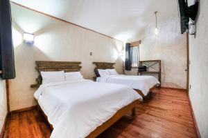 Capital O Collection O Casona De Minas Mineral del Monte客房内的一张或多张床位