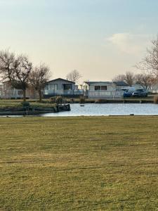 インゴールドメルズにある6 berth Waterside Ingoldmells Skegness J4 Santanavan 10の家と草原のある水域