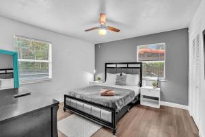 a bedroom with a bed and a ceiling fan at Hollywood Beach & Casino Heated Pool House in Hollywood +50 photos
