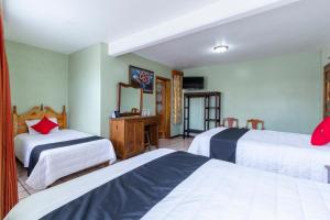 Postel nebo postele na pokoji v ubytování Capital O Hospedaje Los Angeles San Cristobal De Las Casas + 37 fotografií