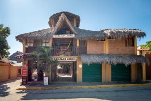 a building with a straw roof and a store at OYO Cabañas Abril, Mazunte in Mazunte