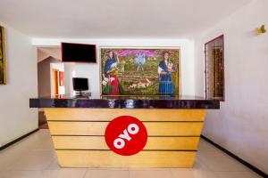 a bar in a room with a painting on the wall at OYO Hotel Rey David, Oaxaca in Ocotlán de Morelos +28 photos