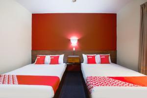 Ένα ή περισσότερα κρεβάτια σε δωμάτιο στο OYO Hotel Maria Teresa Inn Oaxaca