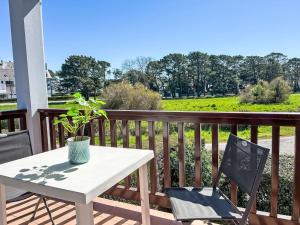 a white table and two chairs on a balcony at Apartment Plein Ciel-1 by Interhome in Carnac-Plage