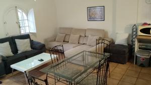 a living room with a couch and a coffee table at Villa Tranquilla in Estepona