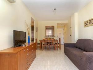 a living room with a couch and a dining room at Apartment Playa Coral I-1 by Interhome in Oropesa del Mar