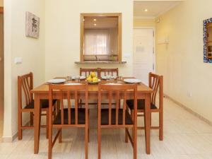 a dining room table with chairs and a bowl of fruit on it at Apartment Playa Coral I-1 by Interhome in Oropesa del Mar