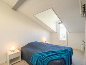 a bedroom with a bed and a window at Holiday Home Les Jardins de l'Océan-38 by Interhome in Pontaillac