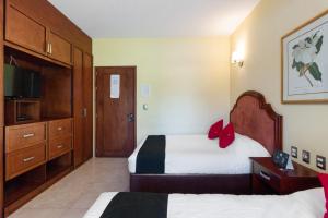 Postel nebo postele na pokoji v ubytování Capital O Hotel Vitalé