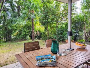 a wooden table with a bowl of fruit on it at Apartment App- Castausio 26 by Interhome in Lugano +25 photos