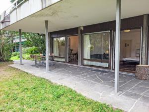 a house with glass doors and a patio at Apartment App- Castausio 26 by Interhome in Lugano