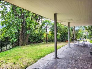a pavilion with a table and chairs in a park at Apartment App- Castausio 26 by Interhome in Lugano