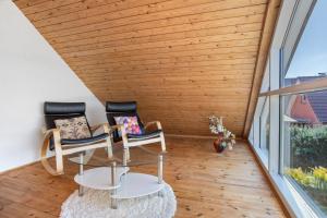 a room with two chairs and a glass table at Ferienwohnung Waldidyll in Wolgast